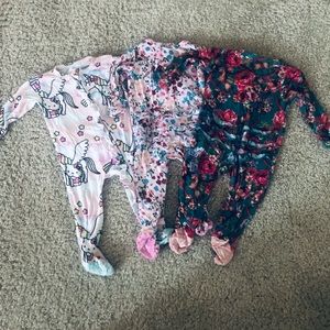 A set of 0-3 month baby girls zip up onesies